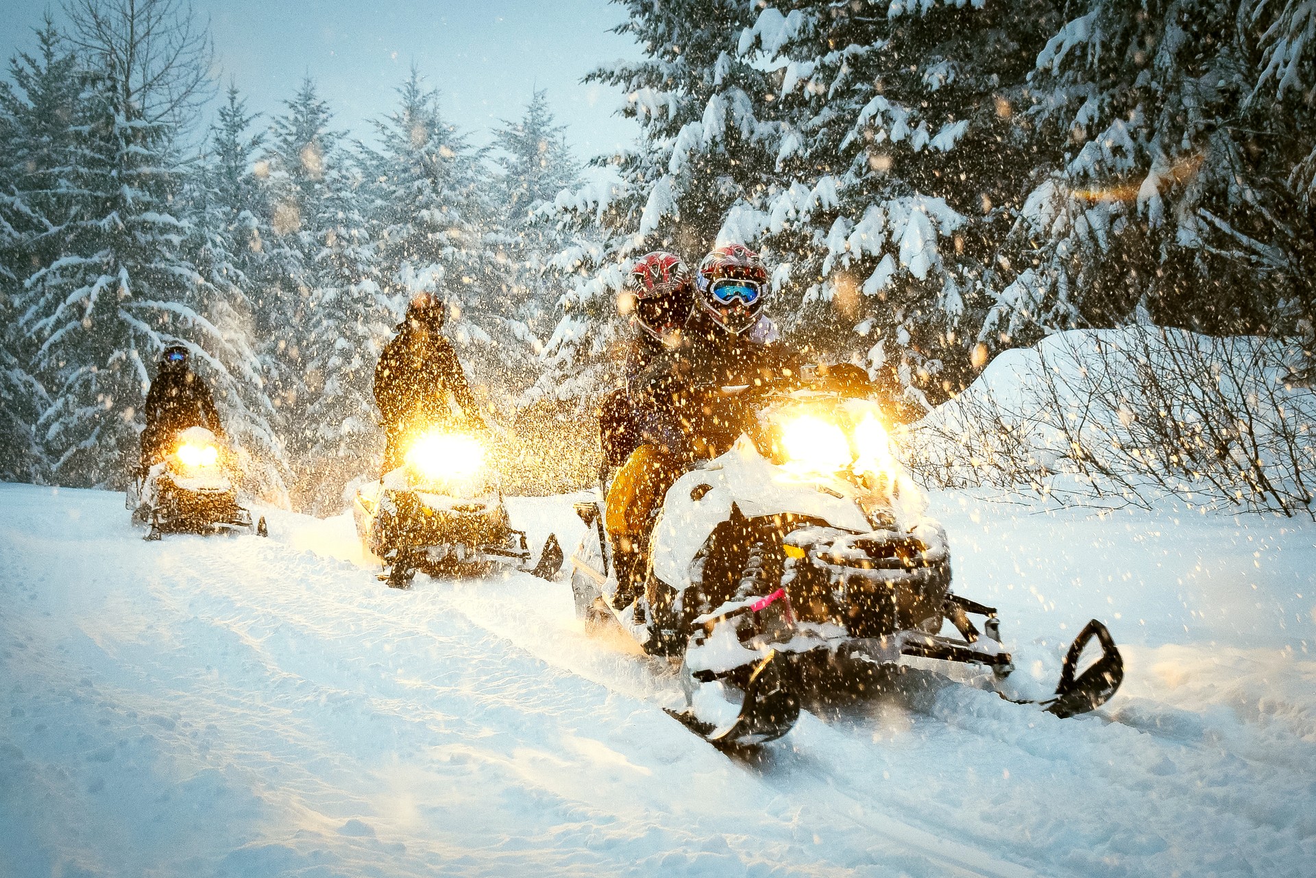 Couple snow mobile in snow storm